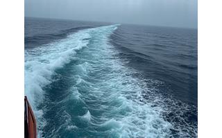 View from a ship's bridge showing rough seas through a window